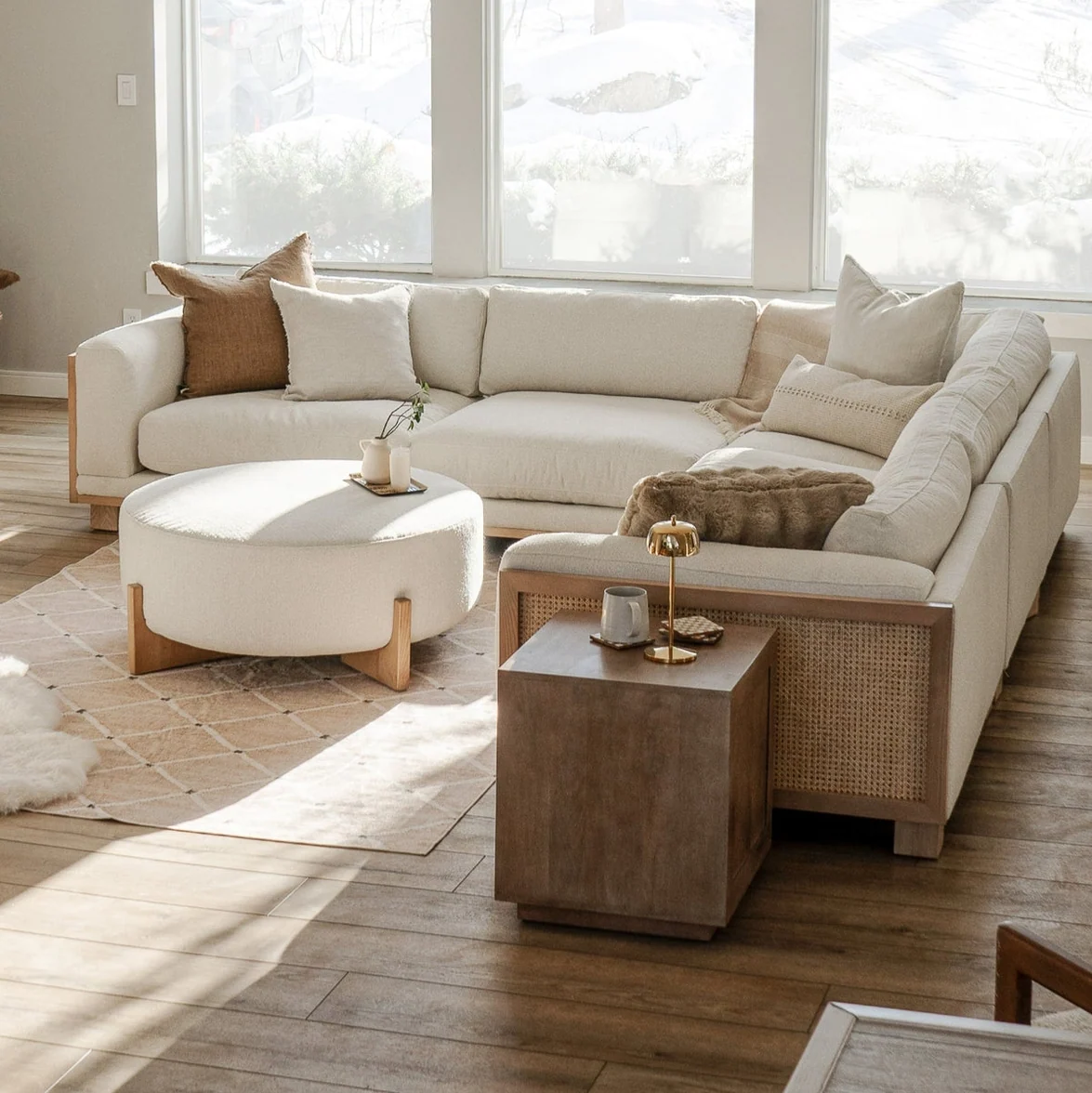 ADOUER WOOD Beige sectional sofa with matching ottoman in a bright living room